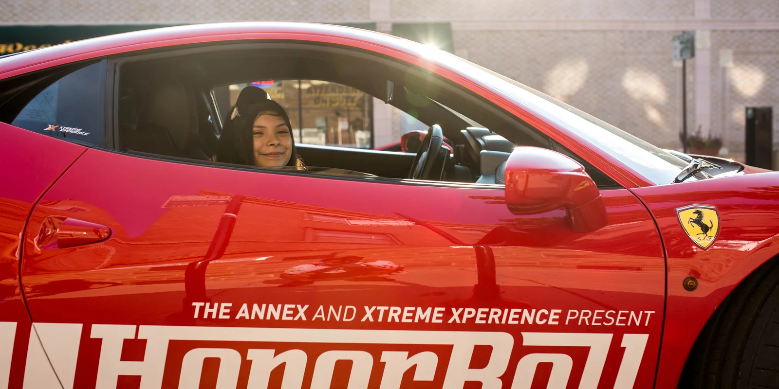 Honor-roll student in a Ferrari branded for the Honor Roll campaign